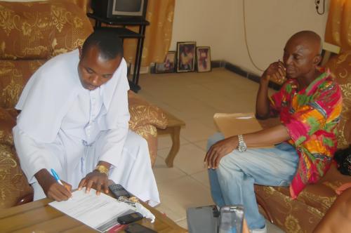 Rev. Eze Ezekiel Igbokwe of St Mark’s Church Arondizuogu signing documents for the foundation.